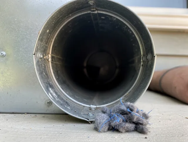 Mansfield Dryer Vent Cleaning technician using specialized equipment to clear severe dryer vent blockage in Mansfield